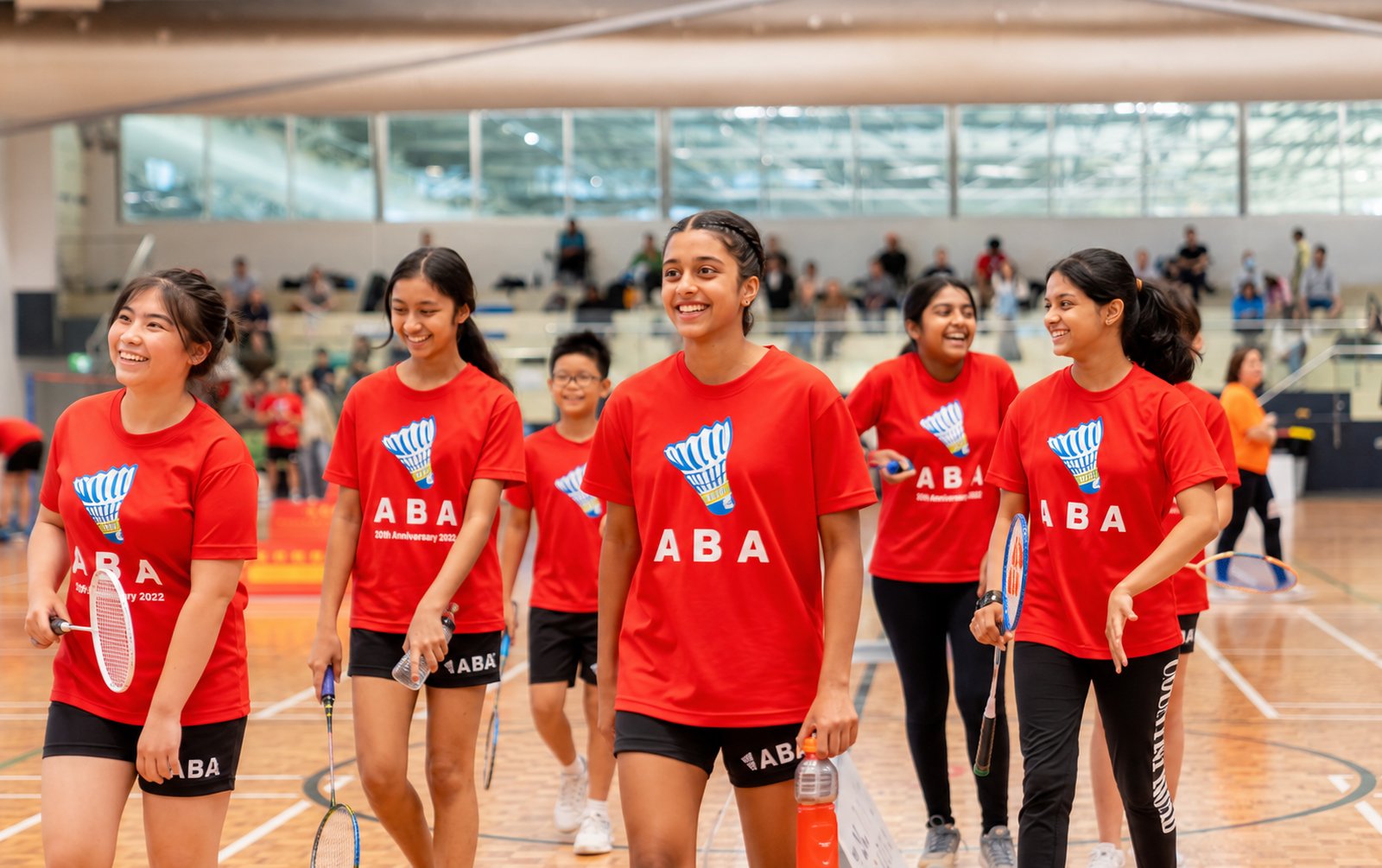 A group of ABA players walking onto the court together at an academy event